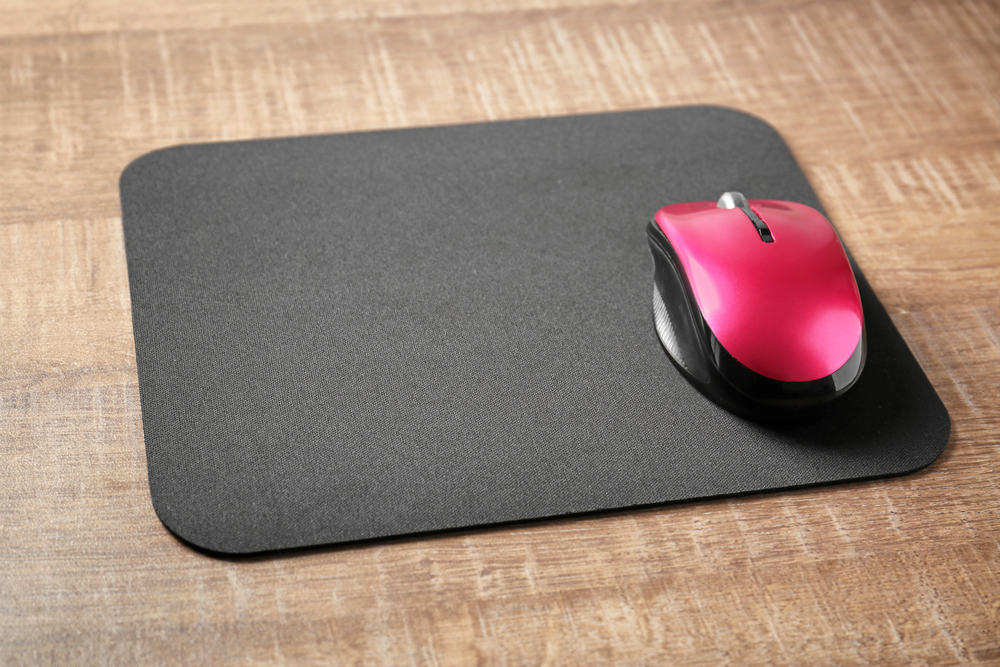 a black mouse pad and red computer mouse