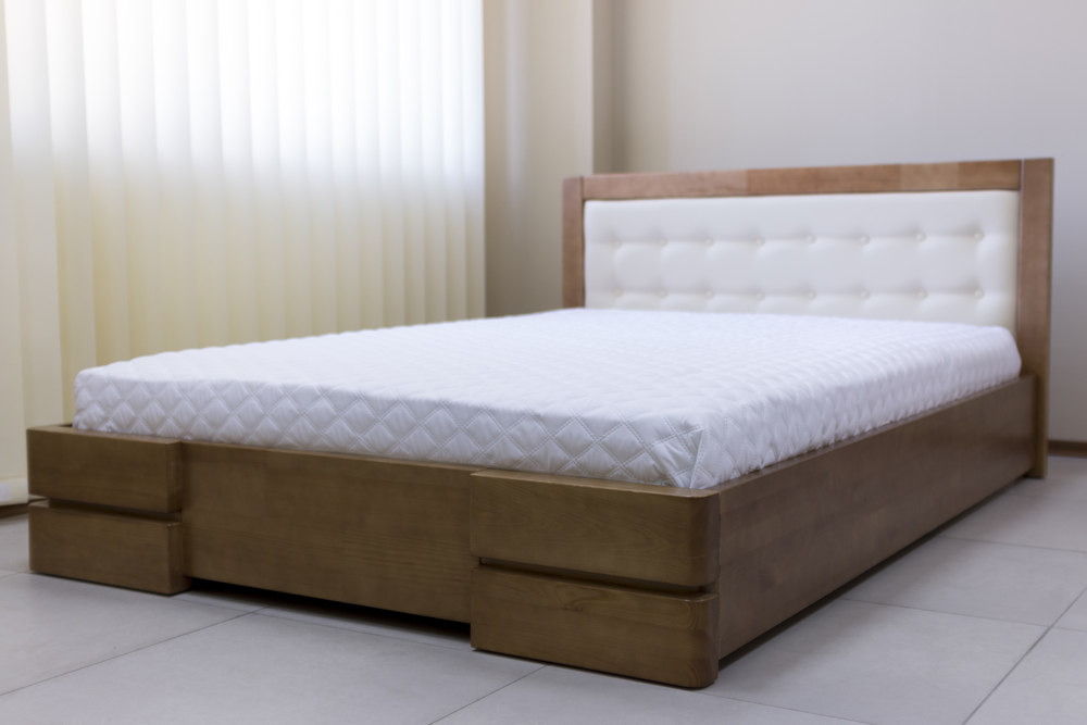 a queen-sized bed with wooden frame