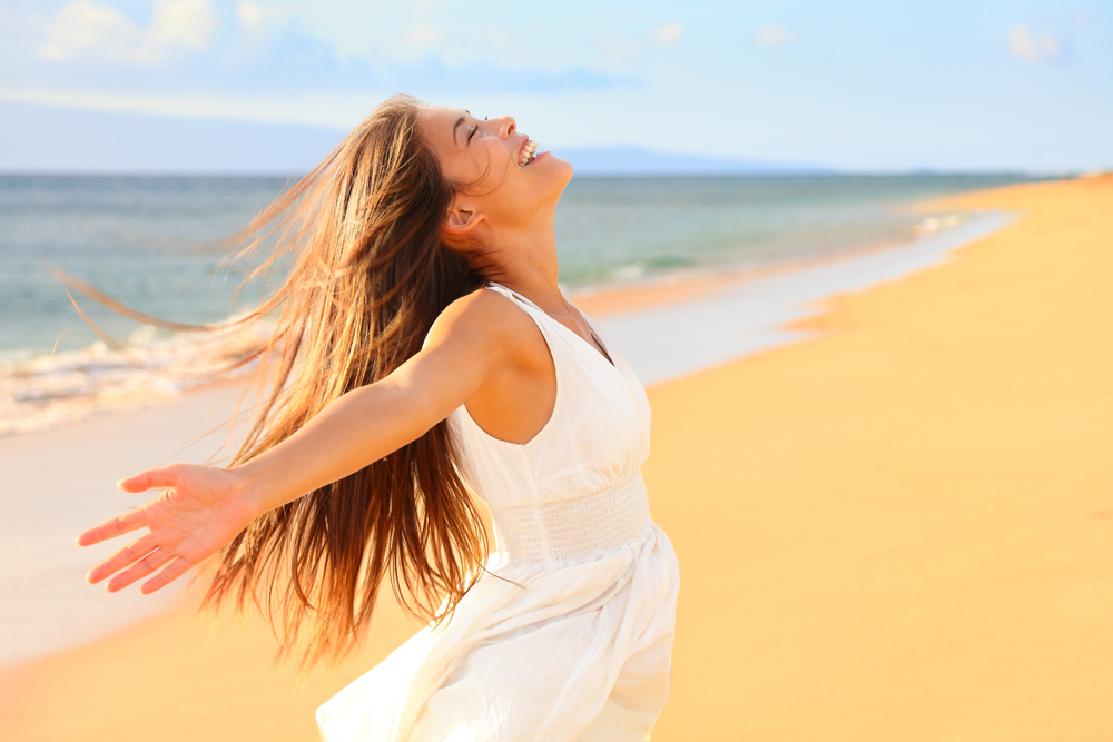 a woman enjoying the warm sea breeze and sunlight